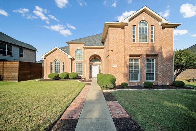 4730 Parkhaven Dr, Garland, TX 75043 - traditional home with brick siding, a shingled roof, fence, and a front lawn