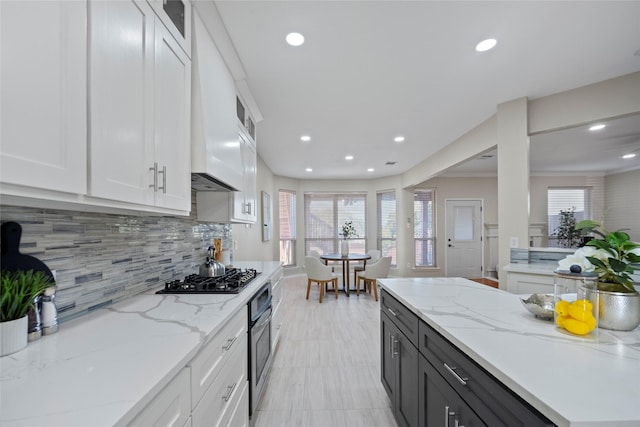 4730 Parkhaven Dr, Garland, TX 75043 - kitchen featuring white cabinets, tasteful backsplash, glass insert cabinets, and gas cooktop