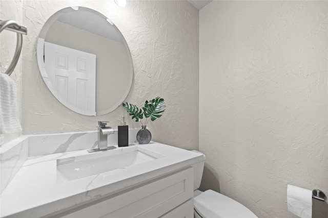 4730 Parkhaven Dr, Garland, TX 75043 - half bathroom with toilet, vanity, and a textured wall