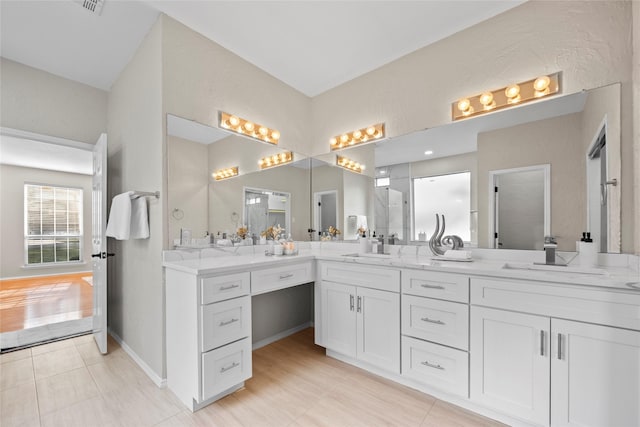 4730 Parkhaven Dr, Garland, TX 75043 - full bath with double vanity, a sink, and baseboards