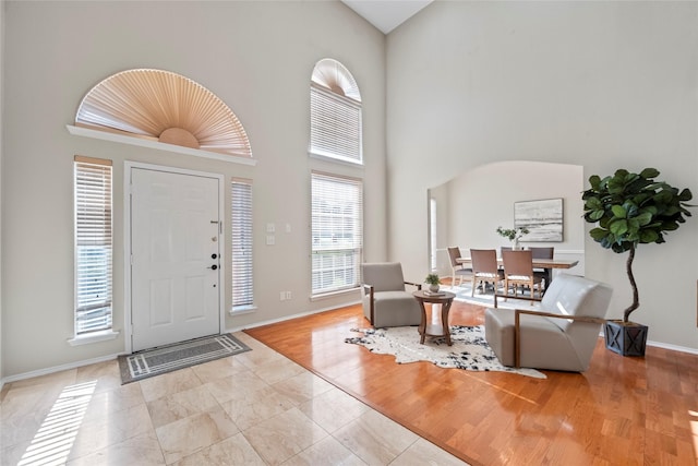4730 Parkhaven Dr, Garland, TX 75043 - foyer with baseboards, a high ceiling, and wood finished floors