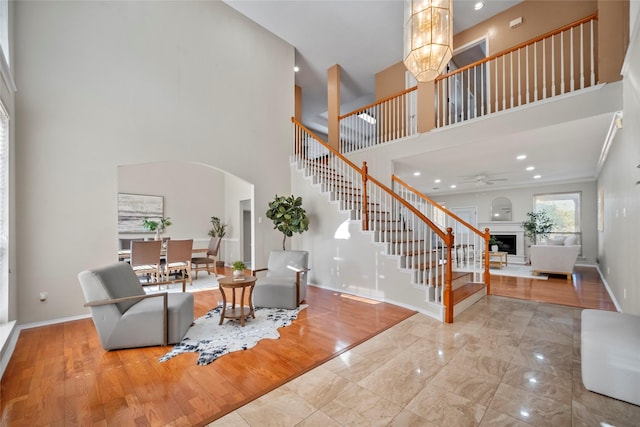 4730 Parkhaven Dr, Garland, TX 75043 - living room featuring baseboards, stairs, a fireplace, wood finished floors, and arched walkways