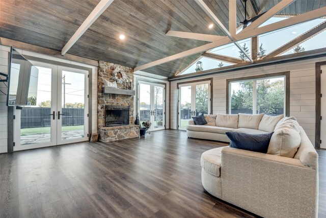 147 Cotton Franklin Rd, Gordonville, TX 76245 - living area featuring french doors, a stone fireplace, dark wood-type flooring, and lofted ceiling with beams