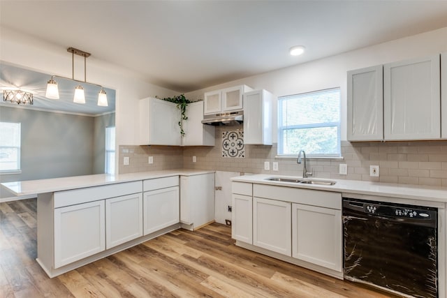 2823 Ingersoll St, Dallas, TX 75212 - kitchen featuring light countertops, a peninsula, dishwasher, a sink, and light wood-style floors
