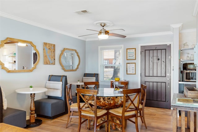 106 Gawayne Dr, Mabank, TX 75156 - dining room featuring visible vents, crown molding, light wood-style floors, and ceiling fan