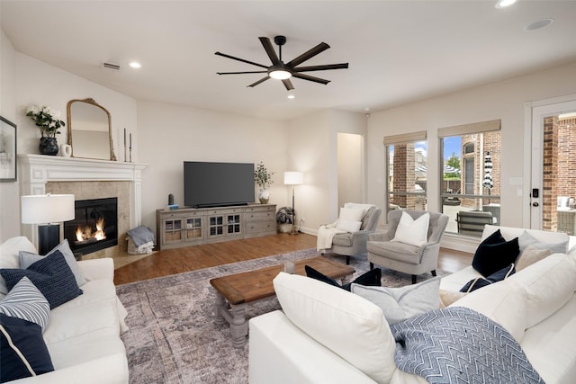 1715 San Jacinto Dr, Allen, TX 75013 - living area with wood finished floors, a ceiling fan, recessed lighting, and a tile fireplace
