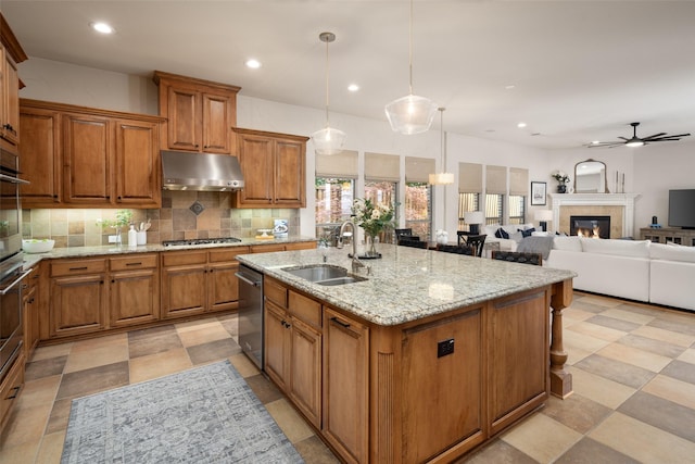 1715 San Jacinto Dr, Allen, TX 75013 - kitchen with a sink, under cabinet range hood, a ceiling fan, brown cabinetry, and recessed lighting