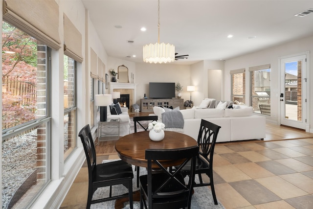 1715 San Jacinto Dr, Allen, TX 75013 - dining room featuring recessed lighting, a fireplace, and a chandelier