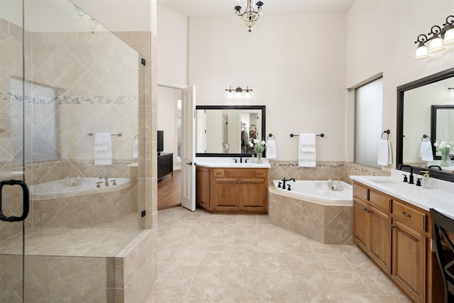 1715 San Jacinto Dr, Allen, TX 75013 - bathroom with a stall shower, a bath, two vanities, tile patterned floors, and a towering ceiling