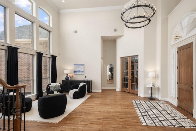 1715 San Jacinto Dr, Allen, TX 75013 - entrance foyer with a high ceiling, french doors, wood finished floors, crown molding, and a chandelier