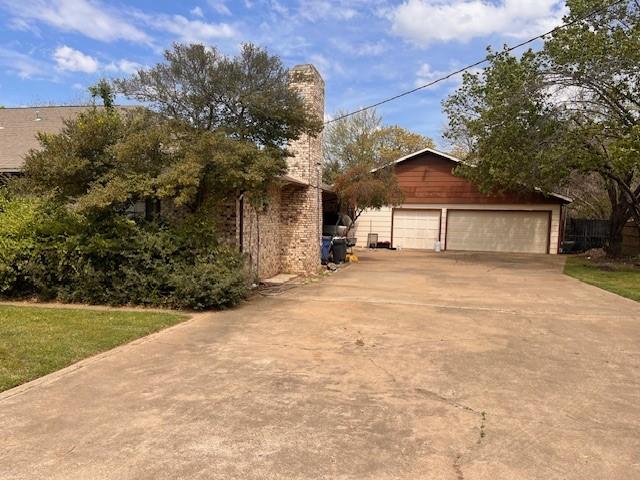 2508 Rolling Ln, Southlake, TX 76092 - exterior space with an outdoor structure, driveway, and a garage