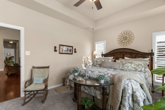 bedroom with baseboards, multiple windows, visible vents, and carpet