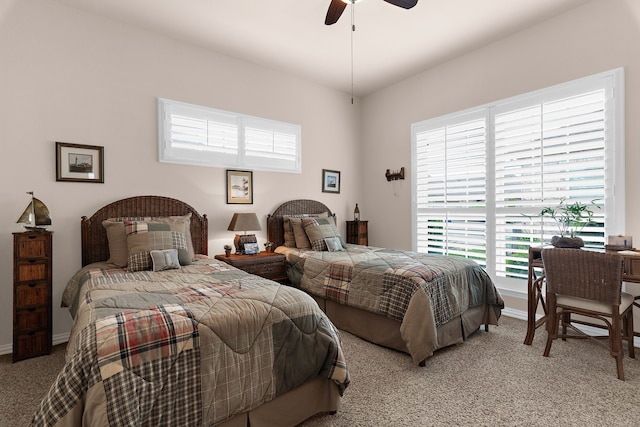 carpeted bedroom featuring a ceiling fan and baseboards