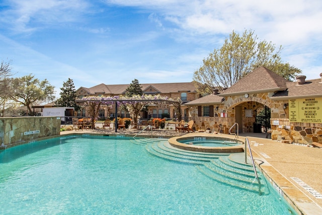 view of swimming pool with a patio area and a pool with connected hot tub
