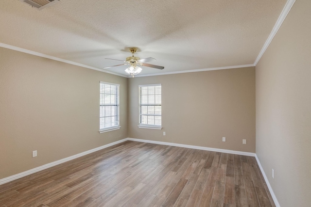 empty room featuring baseboards, a textured ceiling, crown molding, ceiling fan, and wood finished floors