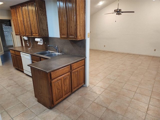 10149 Regent Row St, Benbrook, TX 76126 - kitchen featuring white dishwasher, dark countertops, a sink, a ceiling fan, and vaulted ceiling