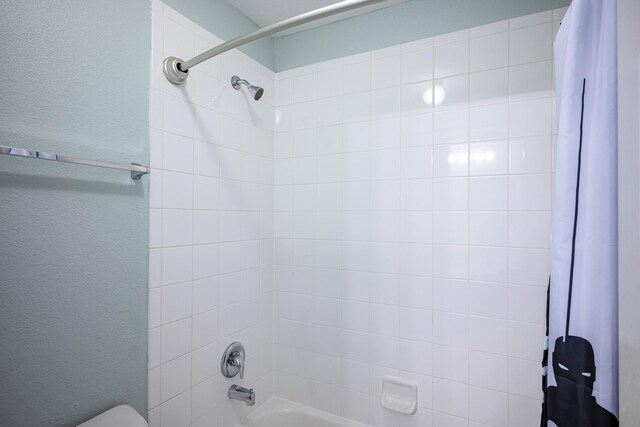 1721 Settlement Way, Aubrey, TX 76227 - bathroom featuring toilet, a textured wall, and shower / bath combo with shower curtain