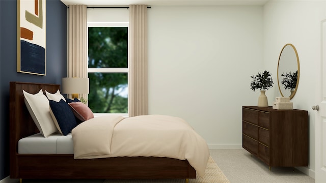 bedroom with light carpet and baseboards
