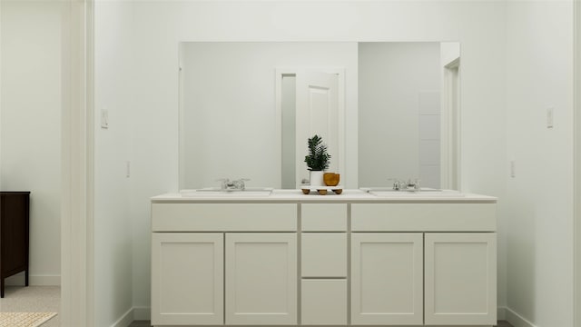 full bath with double vanity, baseboards, and a sink