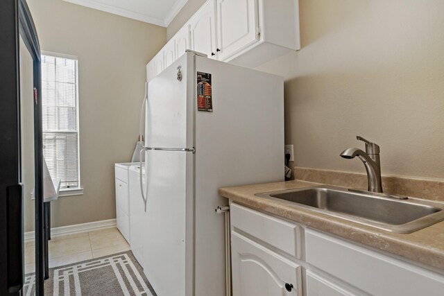 4580 Southgate Dr, Plano, TX 75024 - washroom featuring light tile patterned floors, ornamental molding, and washing machine and clothes dryer