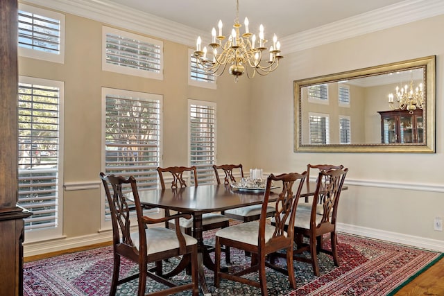 4580 Southgate Dr, Plano, TX 75024 - dining area with wood finished floors, a chandelier, baseboards, and crown molding