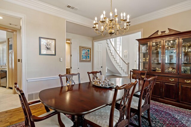 4580 Southgate Dr, Plano, TX 75024 - dining space with a chandelier, stairs, ornamental molding, baseboards, and light wood-style flooring