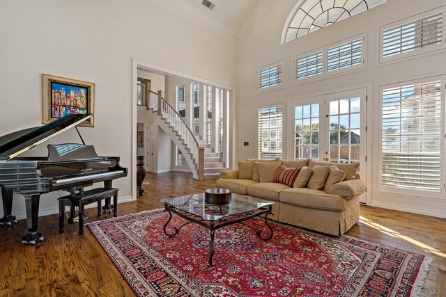 4580 Southgate Dr, Plano, TX 75024 - living area with ornamental molding, wood finished floors, a high ceiling, stairs, and baseboards