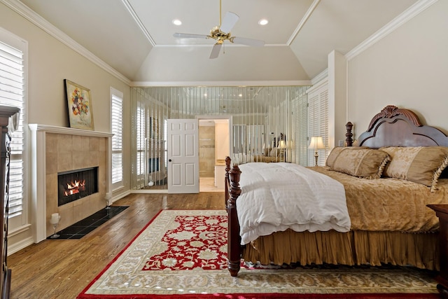4580 Southgate Dr, Plano, TX 75024 - bedroom with lofted ceiling, wood finished floors, a tiled fireplace, crown molding, and a ceiling fan