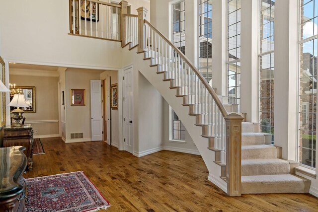4580 Southgate Dr, Plano, TX 75024 - foyer with baseboards, healthy amount of natural light, stairway, a chandelier, and a high ceiling