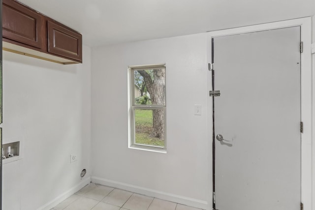 322 W Mcvey Ave, Dallas, TX 75224 - clothes washing area featuring washer hookup, electric dryer hookup, cabinet space, light tile patterned floors, and baseboards