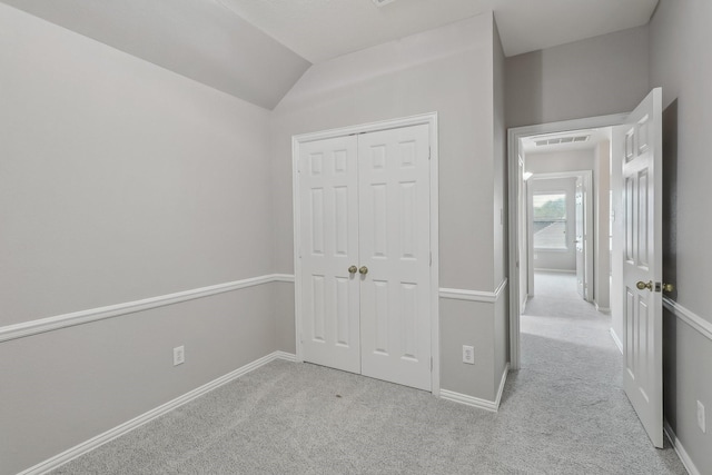 322 W Mcvey Ave, Dallas, TX 75224 - unfurnished bedroom featuring a closet, visible vents, baseboards, carpet flooring, and vaulted ceiling