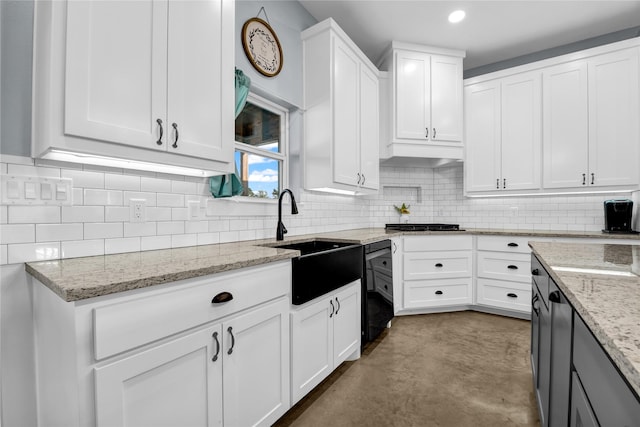 kitchen with a sink, white cabinetry, recessed lighting, finished concrete floors, and backsplash