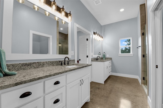 full bathroom featuring visible vents, a shower stall, two vanities, a sink, and baseboards