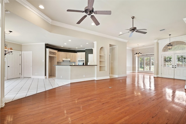 2411 Oak Shadow Ct, Arlington, TX 76017 - unfurnished living room featuring a chandelier, light wood-style floors, crown molding, a ceiling fan, and recessed lighting