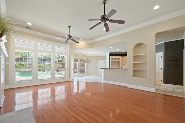 2411 Oak Shadow Ct, Arlington, TX 76017 - unfurnished living room featuring built in shelves, light wood-style floors, a ceiling fan, ornamental molding, and baseboards