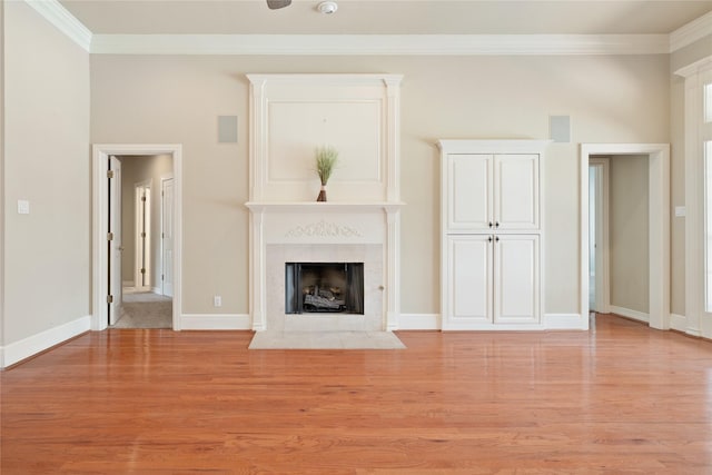2411 Oak Shadow Ct, Arlington, TX 76017 - unfurnished living room with crown molding, light wood-type flooring, a fireplace, and baseboards