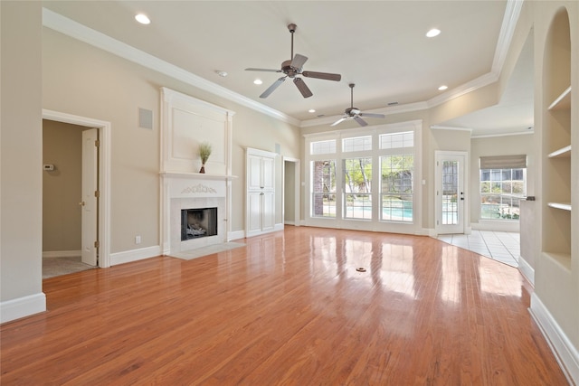 2411 Oak Shadow Ct, Arlington, TX 76017 - unfurnished living room featuring ceiling fan, a high end fireplace, light wood-style flooring, recessed lighting, and baseboards