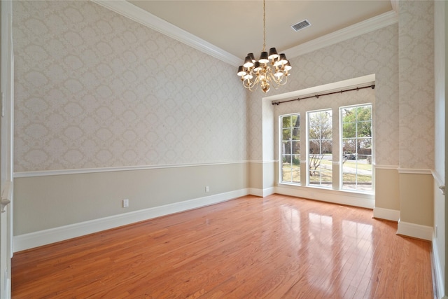 2411 Oak Shadow Ct, Arlington, TX 76017 - empty room featuring a chandelier, light wood finished floors, wallpapered walls, ornamental molding, and baseboards