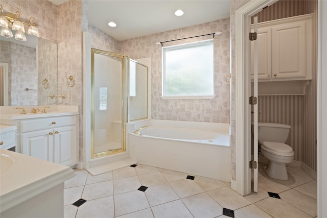 2411 Oak Shadow Ct, Arlington, TX 76017 - bathroom featuring vanity, a bath, a stall shower, tile patterned flooring, and toilet