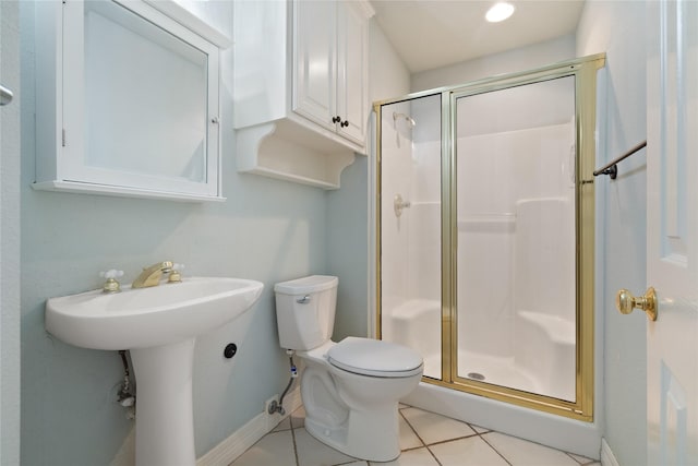 2411 Oak Shadow Ct, Arlington, TX 76017 - bathroom featuring a stall shower, toilet, tile patterned flooring, and baseboards