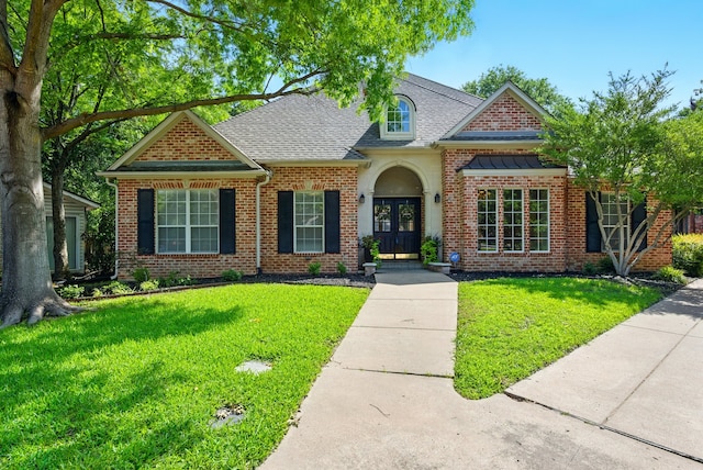 2411 Oak Shadow Ct, Arlington, TX 76017 - view of front of property with french doors, a front yard, roof with shingles, and brick siding