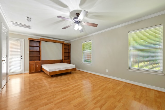 2411 Oak Shadow Ct, Arlington, TX 76017 - unfurnished bedroom featuring light wood finished floors, multiple windows, baseboards, and crown molding