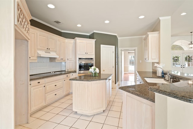 2411 Oak Shadow Ct, Arlington, TX 76017 - kitchen featuring stainless steel oven, under cabinet range hood, a sink, electric cooktop, and tasteful backsplash