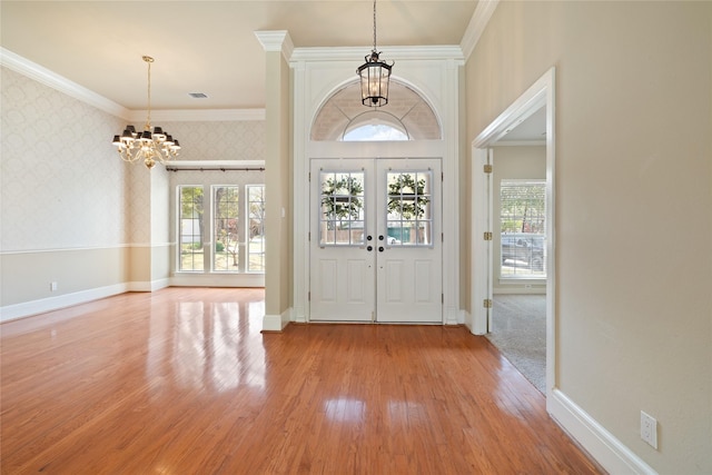 2411 Oak Shadow Ct, Arlington, TX 76017 - foyer featuring a chandelier, wallpapered walls, crown molding, light wood-style flooring, and baseboards