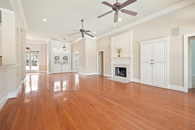 2411 Oak Shadow Ct, Arlington, TX 76017 - unfurnished living room featuring a ceiling fan, ornamental molding, a fireplace with flush hearth, light wood-style flooring, and recessed lighting