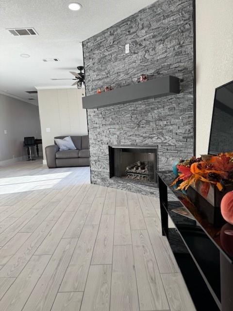 4000 Black Butte Dr, Denton, TX 76210 - living room featuring wood finished floors, a fireplace, ceiling fan, ornamental molding, and recessed lighting