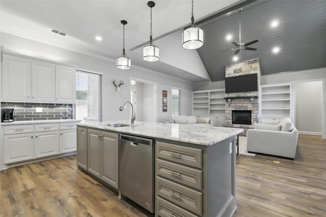 1011 Cardinal Cv, Graford, TX 76449 - kitchen with ceiling fan, white cabinetry, a fireplace, a sink, and dishwasher