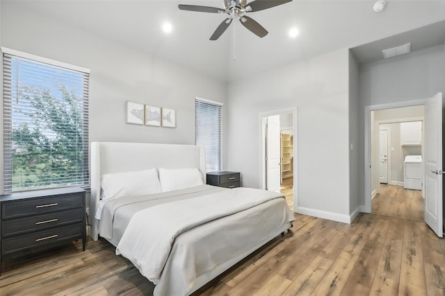 1011 Cardinal Cv, Graford, TX 76449 - bedroom featuring washer / clothes dryer, multiple windows, high vaulted ceiling, wood finished floors, and baseboards
