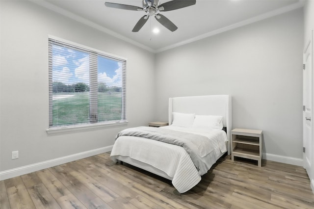 1011 Cardinal Cv, Graford, TX 76449 - bedroom featuring crown molding, baseboards, wood finished floors, and ceiling fan