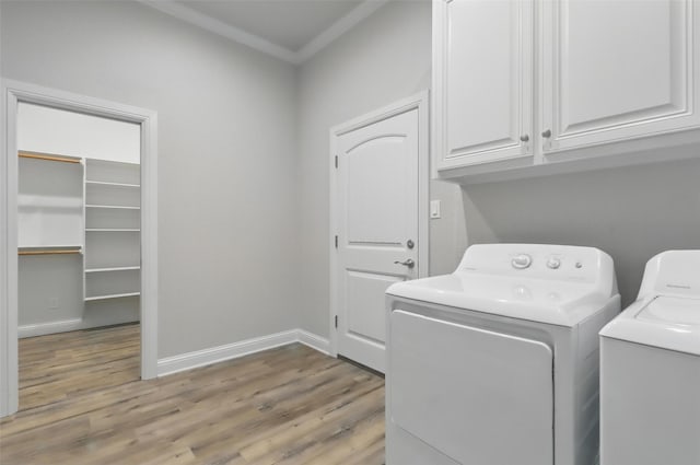 1011 Cardinal Cv, Graford, TX 76449 - laundry room with cabinet space, independent washer and dryer, light wood finished floors, ornamental molding, and baseboards